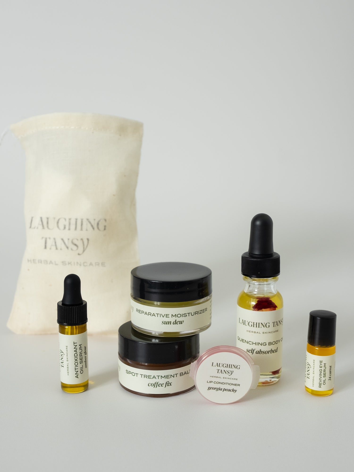 small bottles stacked together with gift bag in background