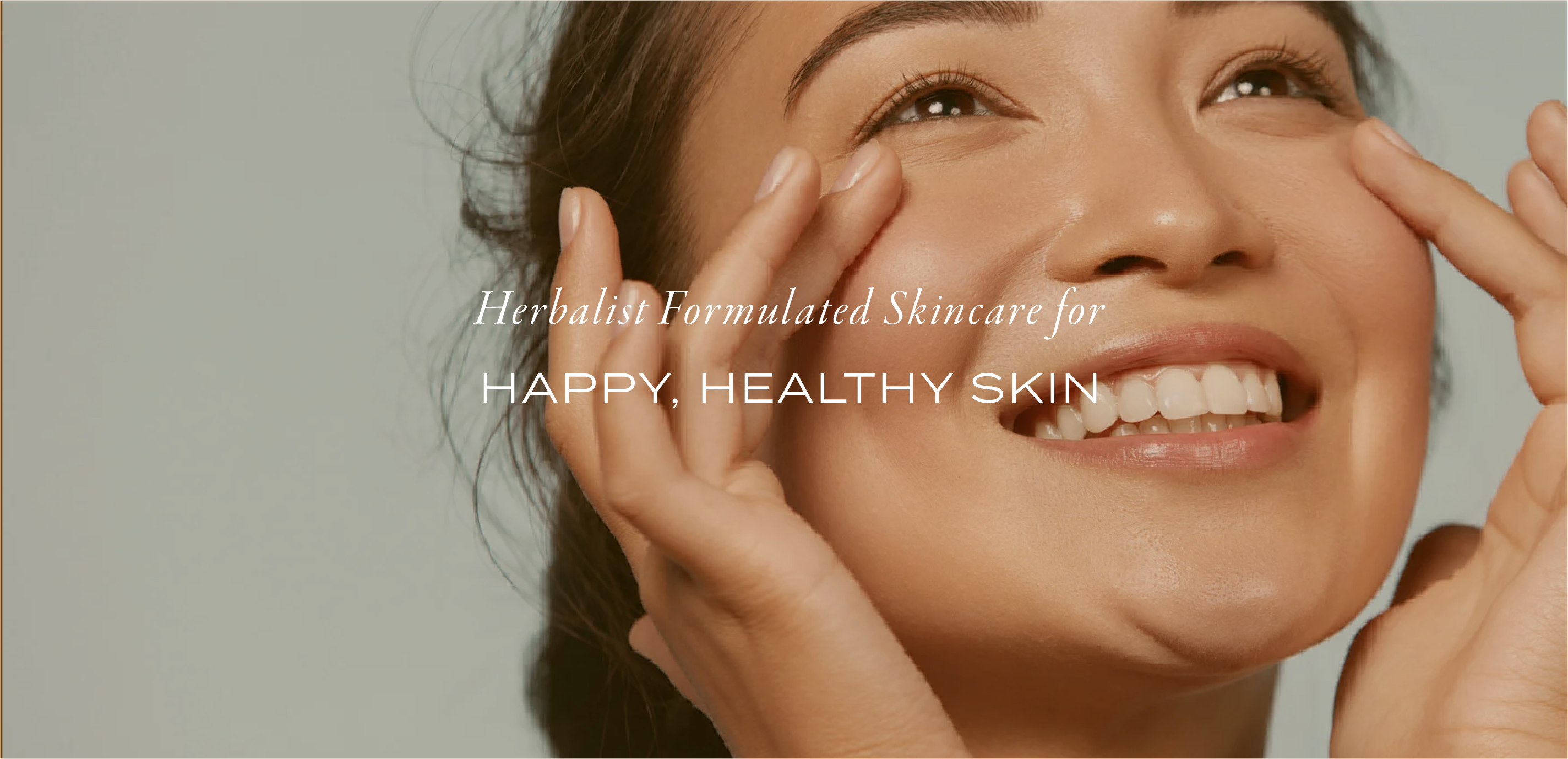 Woman applying moisturizer to face smiling with words on top that say, herbalist formulated skincare for happy, healthy skin